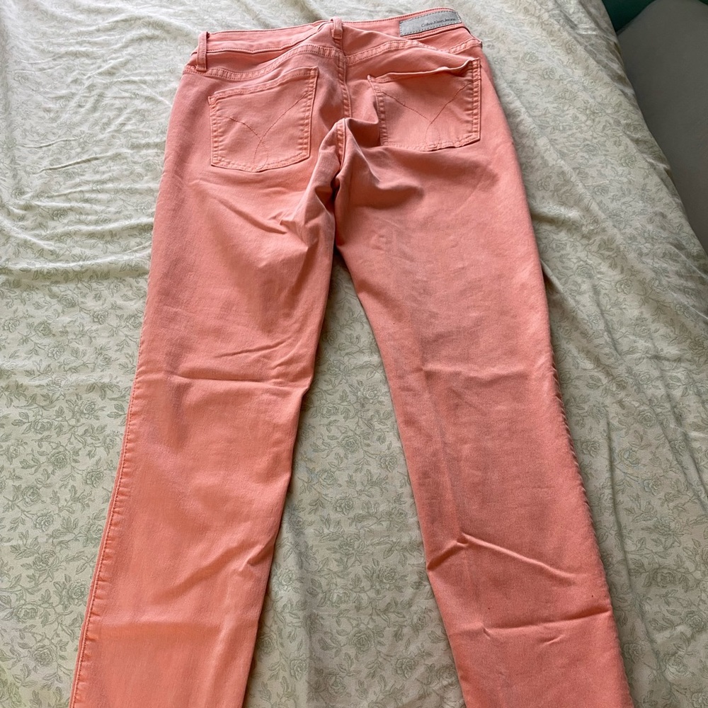 Salmon colored Calvin Klein jeans